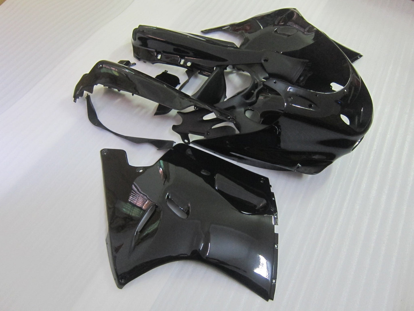 Black fairing kit for a 1990, 1991 & 1992 Kawasaki ZX-11 / ZZR1100 D Model motorcycle. This is a compression molded fairing kit which will require modifications for proper fitment